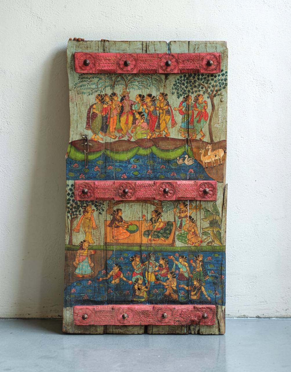 Inspired by the timeless beauty of Madhuban, this painted teak panel captures a serene narrative through intricate folk-inspired artwork and naturally aged wood. 