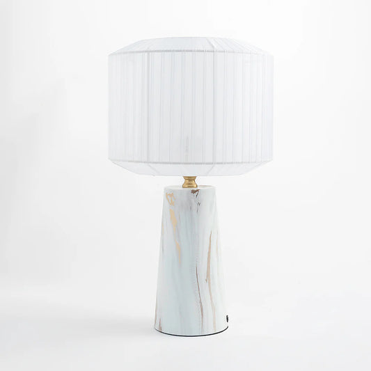 Featuring a marble-finish metal base paired with a pleated ribbon shade,