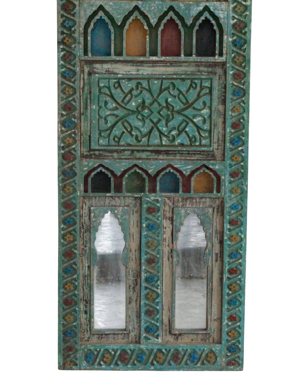 An ornate rectangular decorative mirror with a distressed turquoise green frame, featuring carved geometric patterns, arched window cutouts with colorful stained-glass-style tops, and two mirrored lower panels.