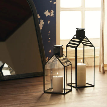 The Modern Lantern Glow Set of 2 brings a sophisticated, contemporary touch to your lighting decor. With sleek, geometric designs and a polished finish, these lanterns offer a perfect balance of style and functionality. 