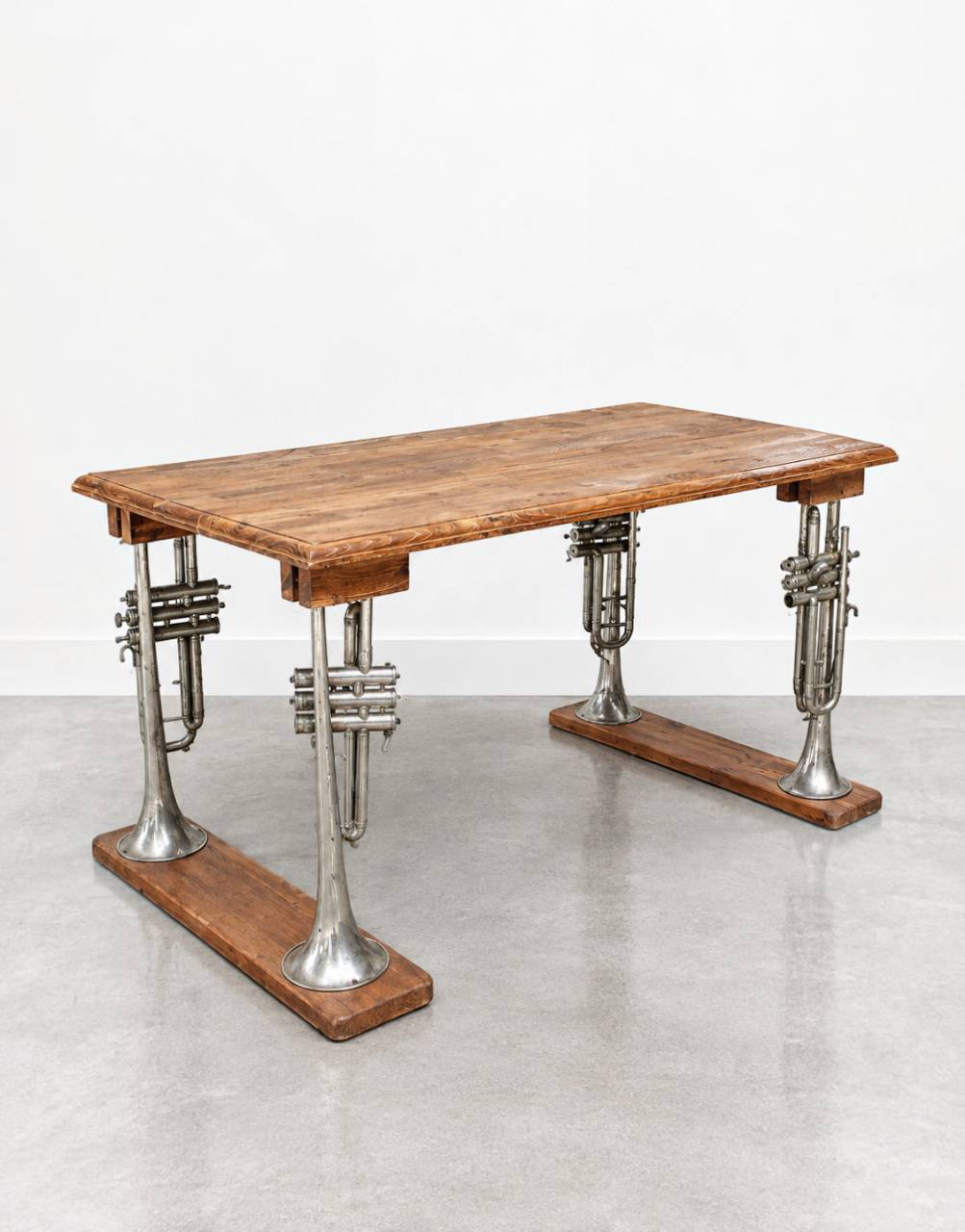 Its distinctive brass trumpet-style base transforms an everyday console into a sculptural statement piece, while the naturally aged teak top showcases rich grain patterns and authentic character.