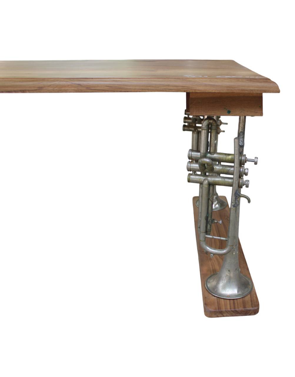 A unique wooden table featuring a natural wood top and a sculptural base made from an antique silver trumpet mounted on a wooden block, shown against a plain white background.