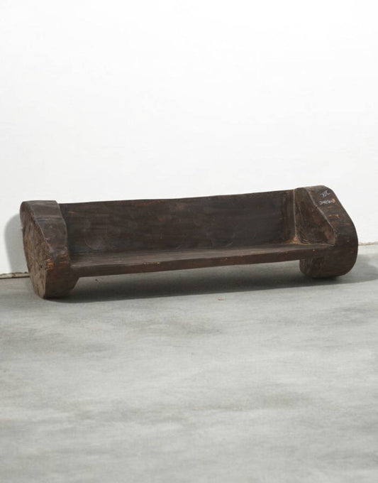 Wooden bench on a gray floor with a white background