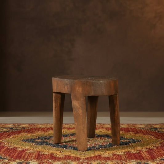 Set of five wooden stools with a blue wall in the background