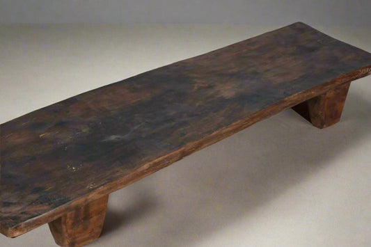 Wooden bench with a dark brown finish on a plain background