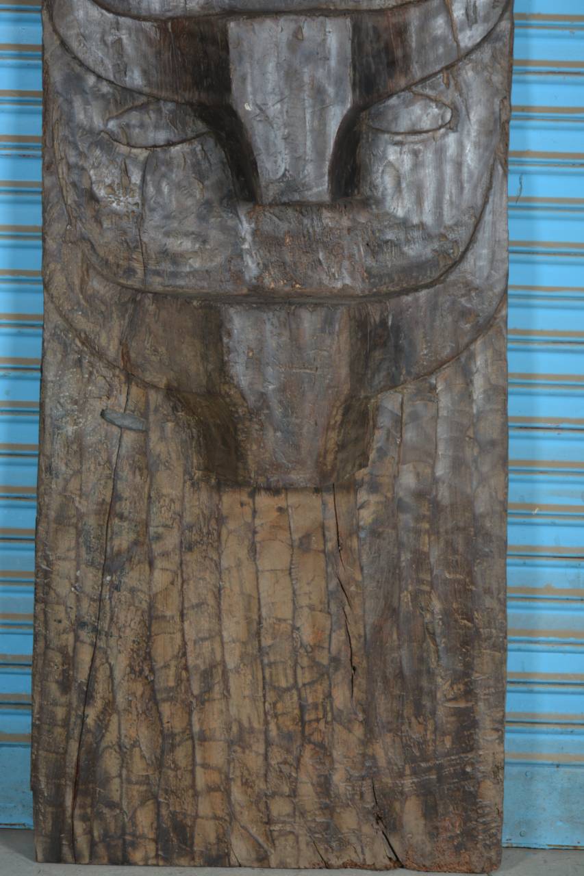 Wooden carvings with abstract designs on a blue background