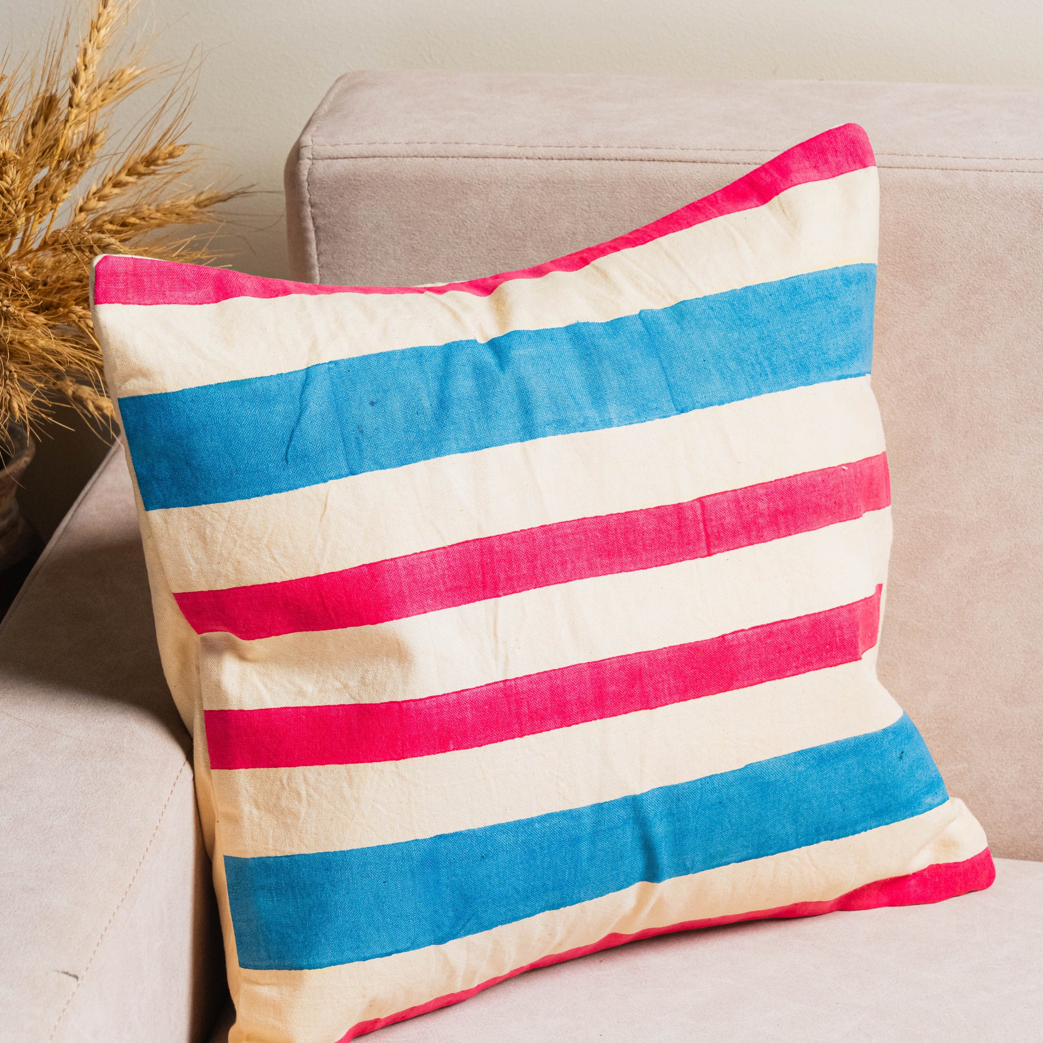 Striped pillow with red, white, and blue colors .