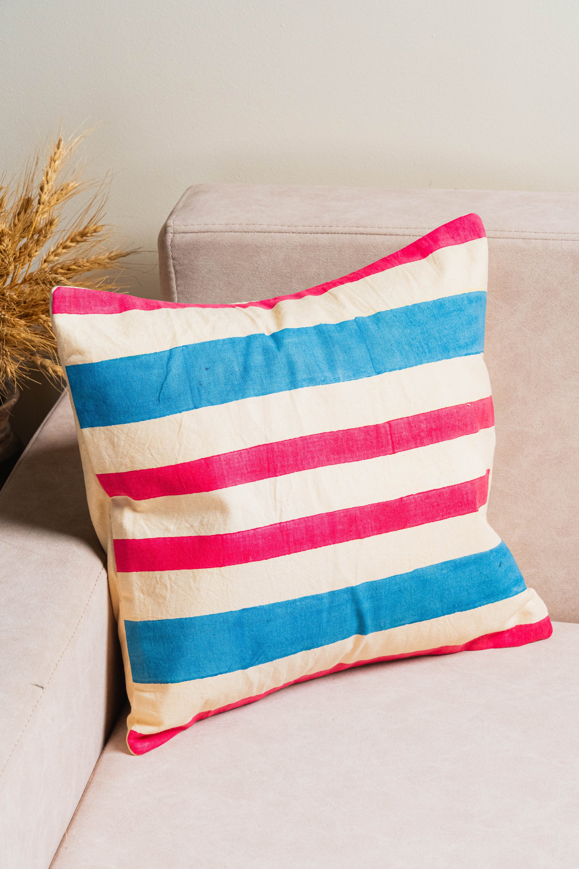 Striped pillow with red, white, and blue colors .