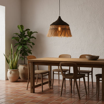 Woven pendant light with natural fiber design against a beige wall.