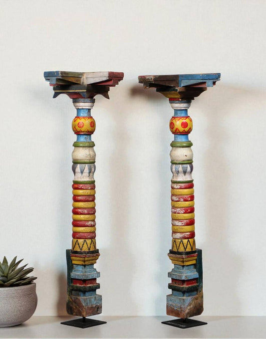 Celebrate heritage and artistry with the Painted Legacy Pillar, a vibrant decor piece handcrafted from recycled wood and supported on a sturdy iron base.