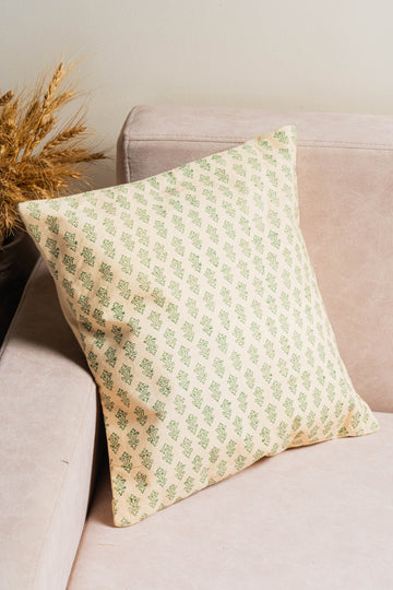 Decorative pillow with green pattern on a beige sofa
