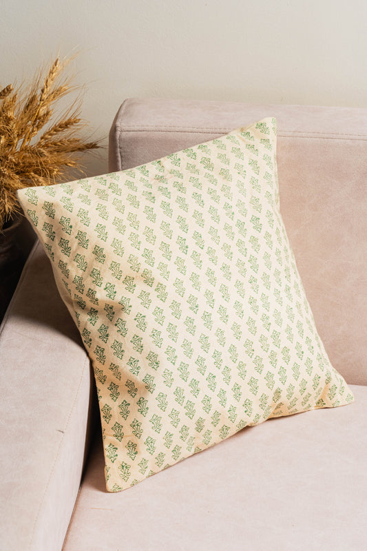 Decorative pillow with green pattern on a beige sofa