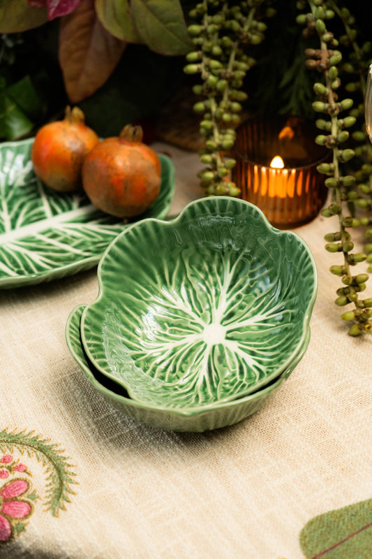 Green ceramic bowl with leaf pattern on a decorative table setting