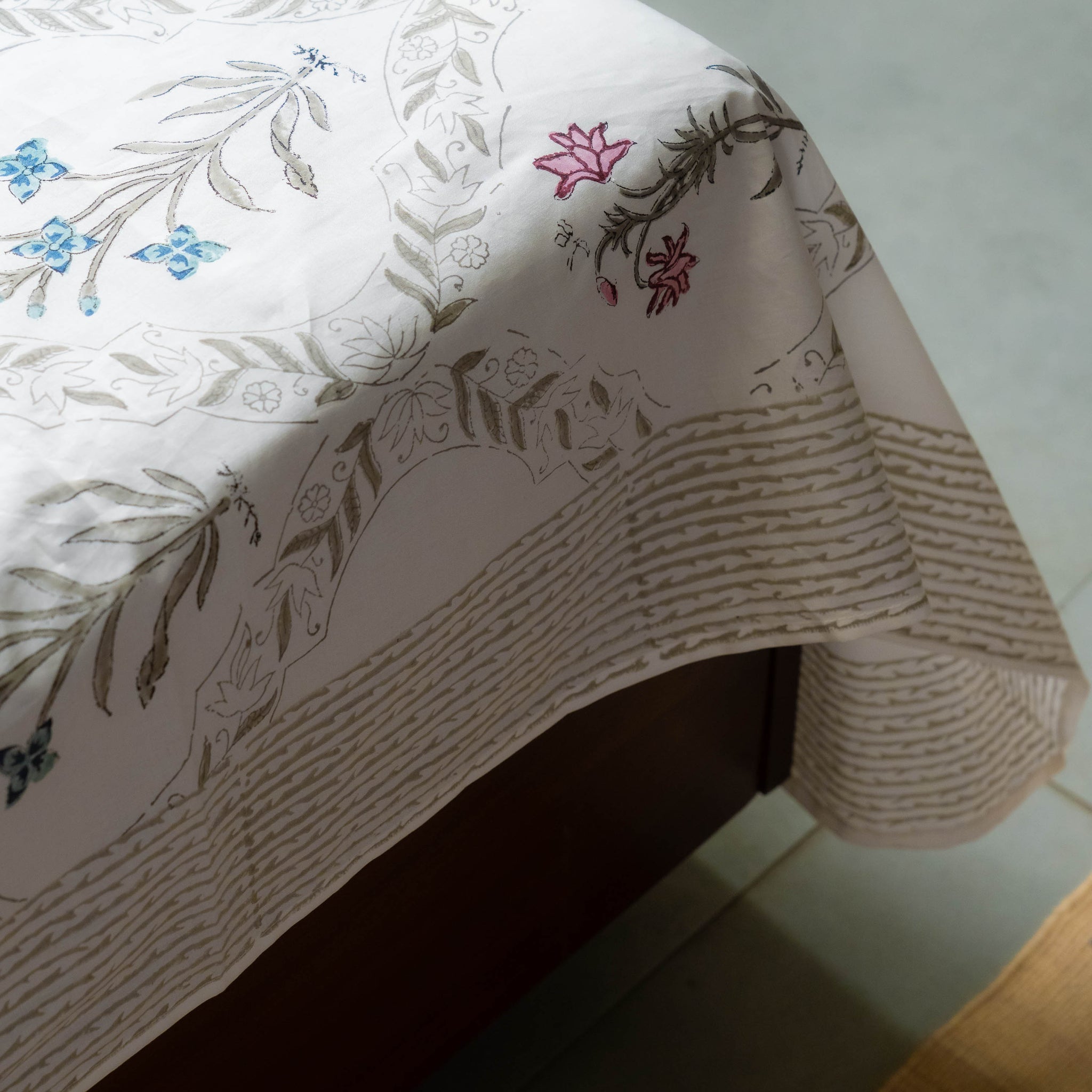 Floral-patterned tablecloth on a table with a white surface