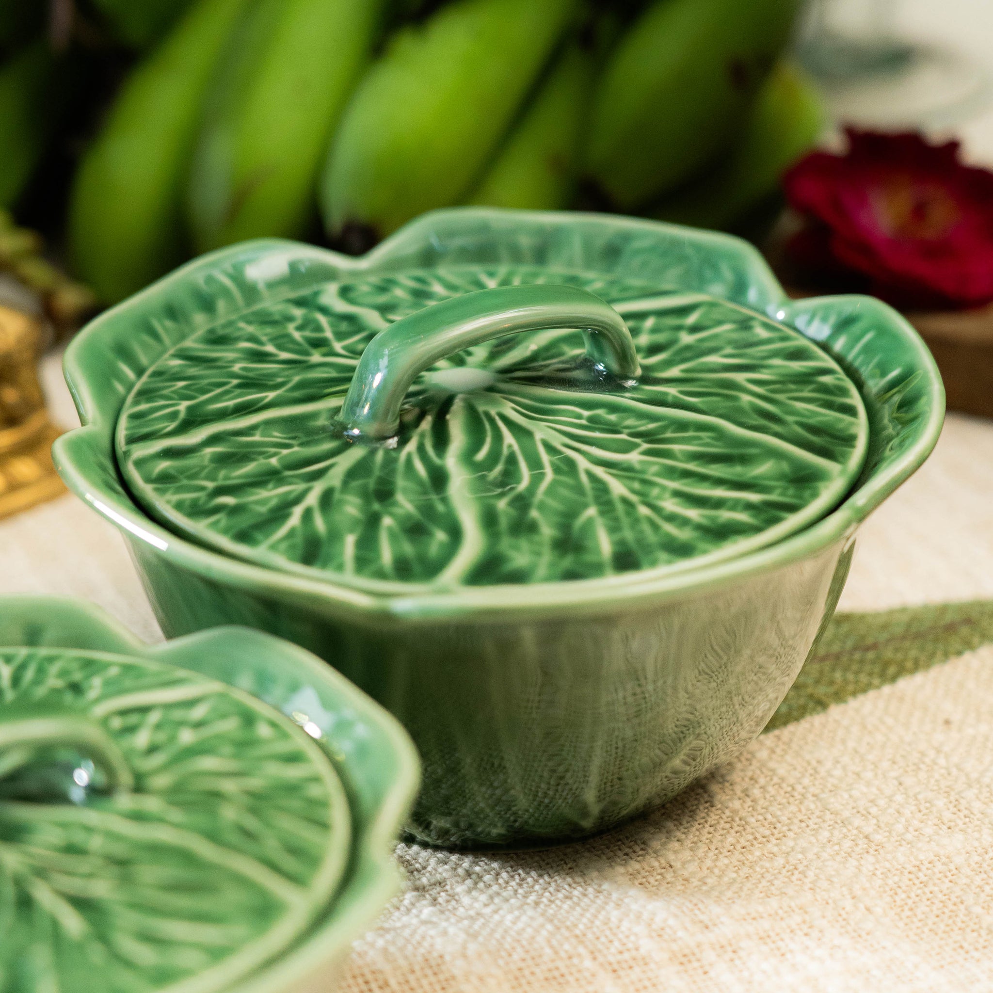 Green ceramic dish with leaf design on a table