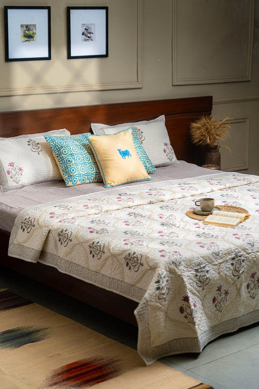 Bedroom with a bed featuring floral bedding and decorative pillows.