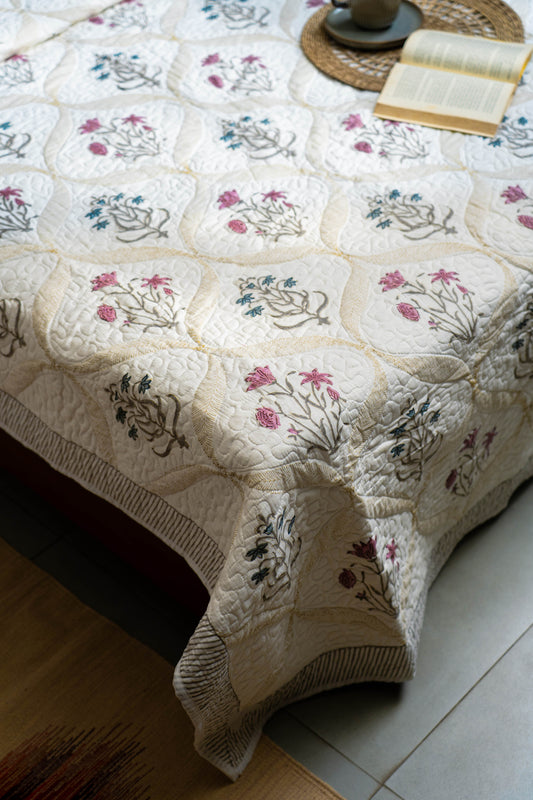 Embroidered tablecloth with floral patterns on a wooden surface.