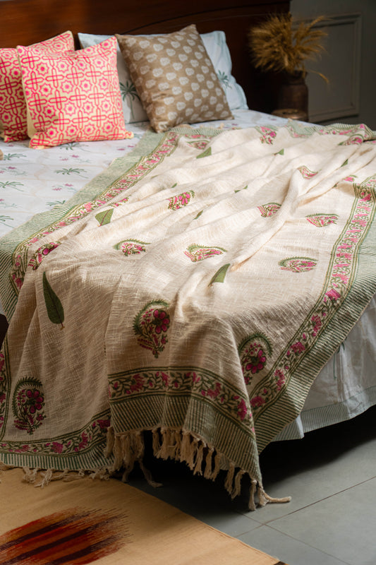 Bed with patterned bedding and pillows in a bedroom setting