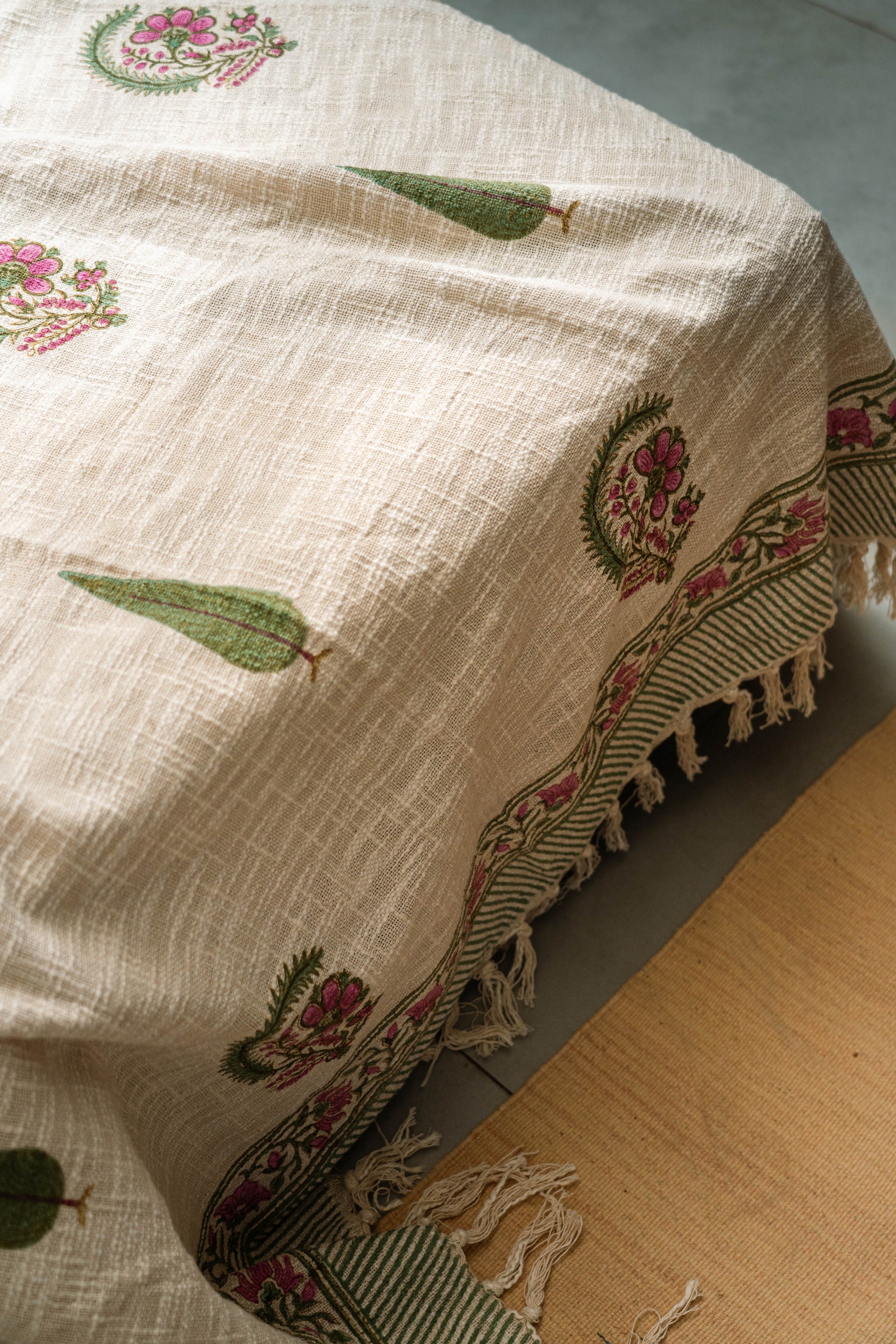Embroidered tablecloth with floral patterns on a wooden surface