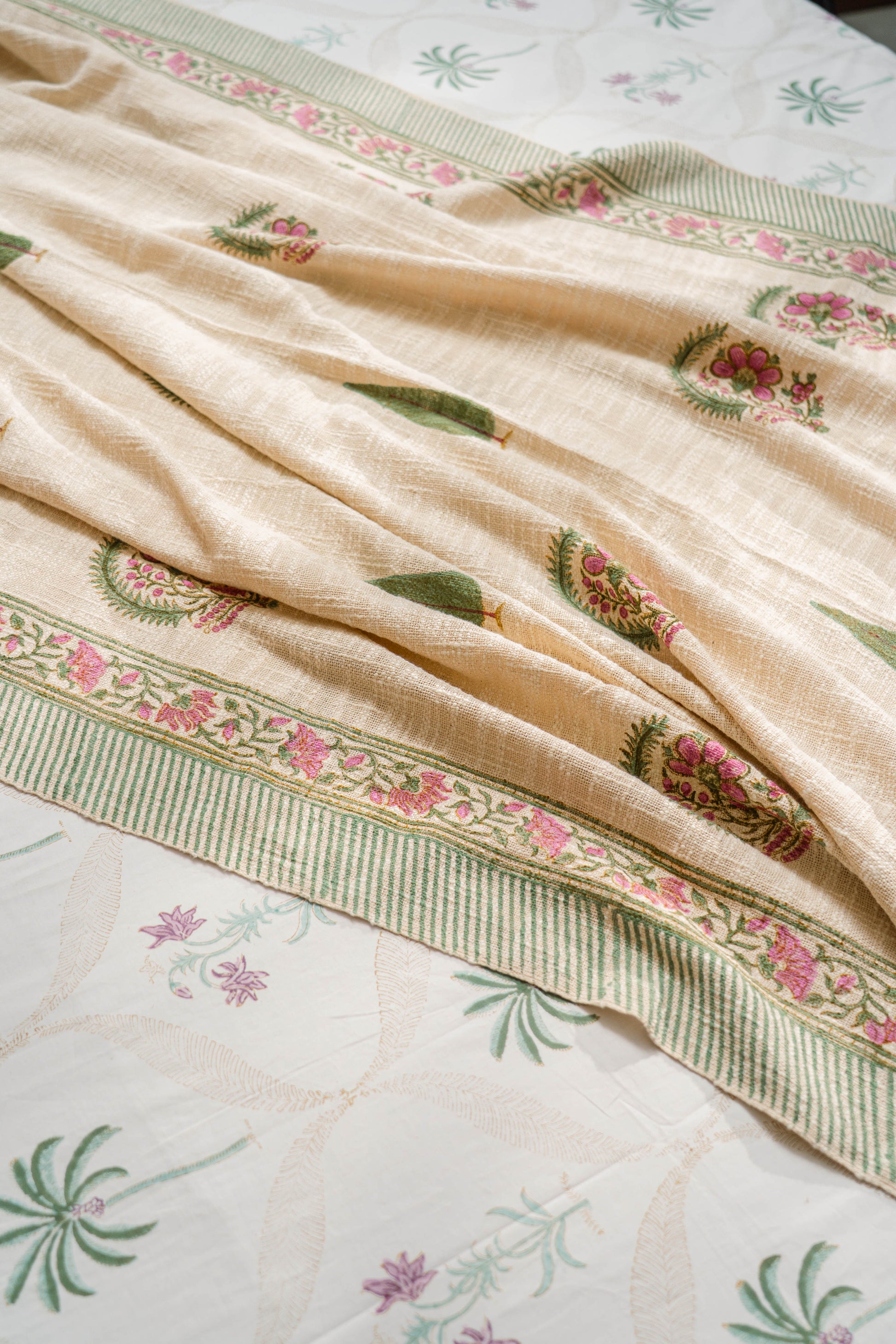 Beige fabric with floral embroidery on a matching background