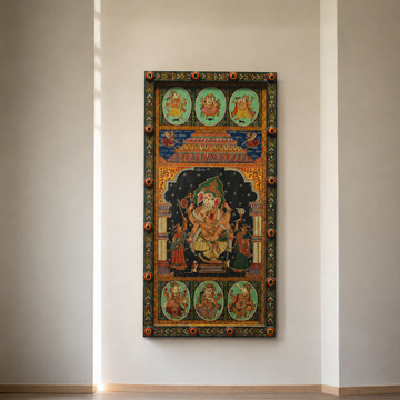 A vertical framed wall art piece featuring a traditional multicolored religious illustration, displayed on a minimalist beige wall above light wood flooring.