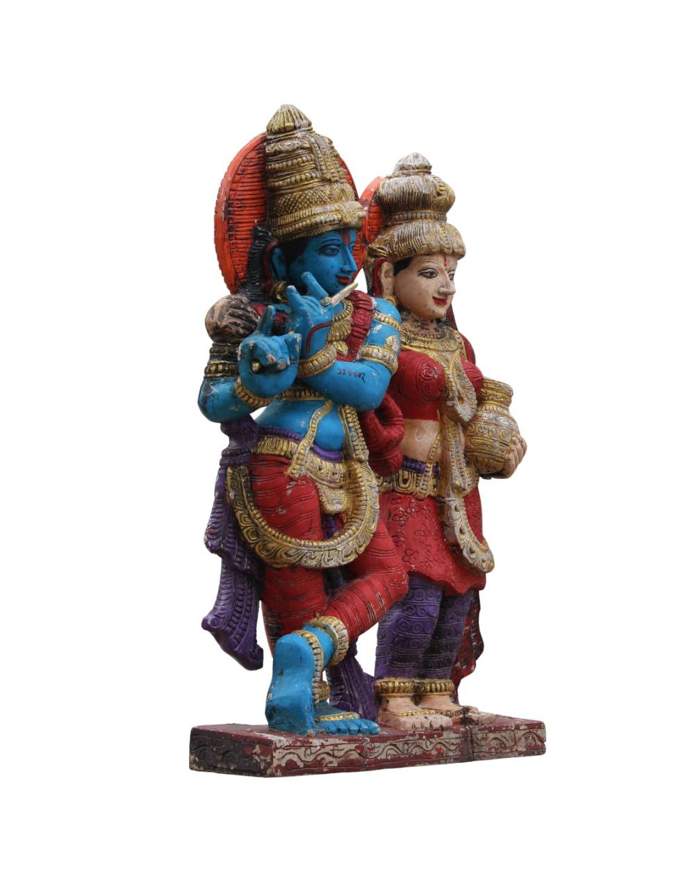 The statue captures Lord Krishna in his signature posture, playing the flute, with Radha lovingly beside him, holding a pot —