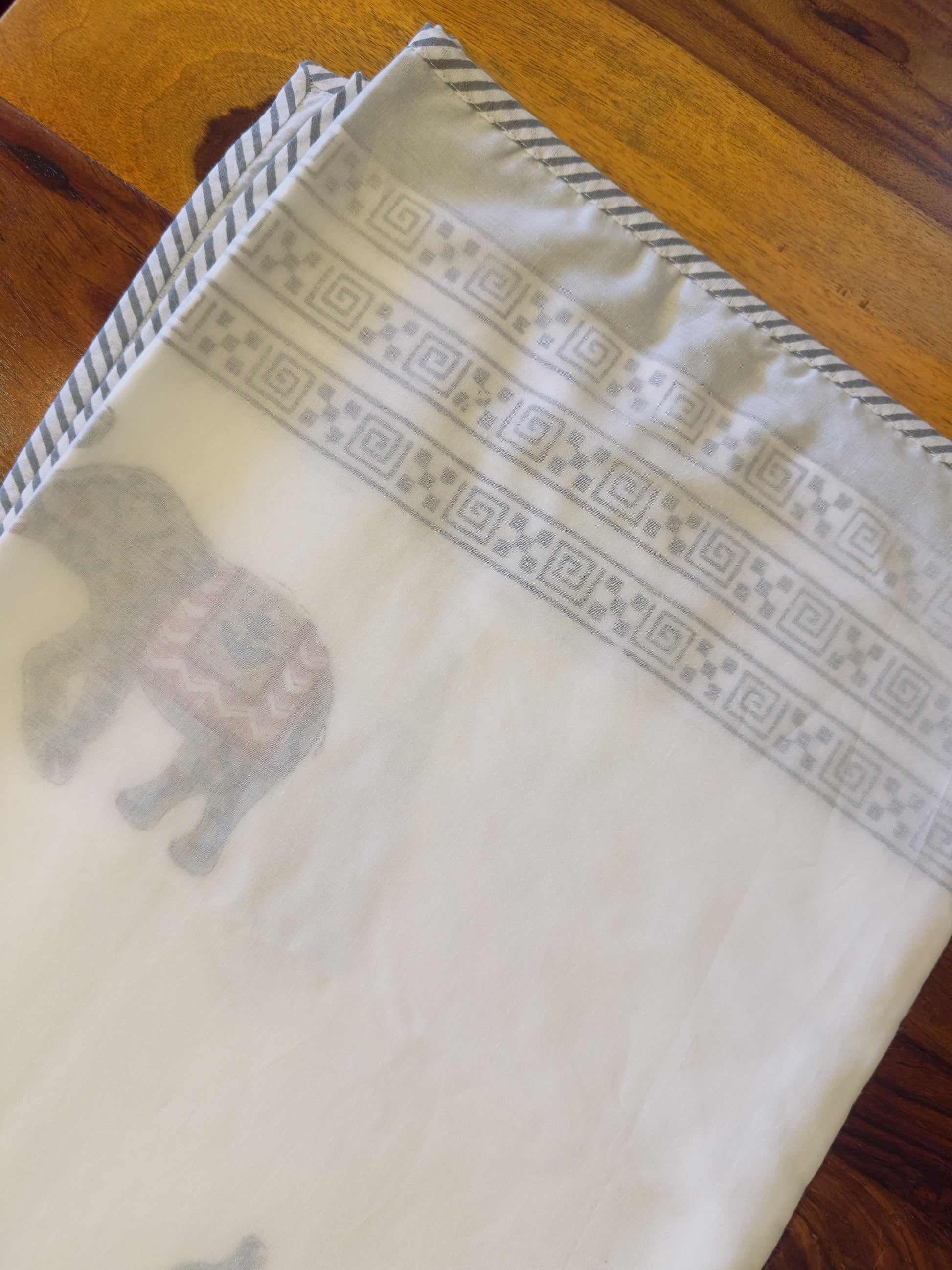 Featuring a subtle handblock print with traditional motifs, this lightweight dohar adds a gentle charm to your sleep space