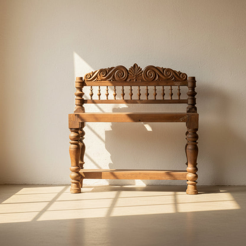 Inspired by the elegant courtyards of India's royal havelis, the Rajangan Heritage Teak Console celebrates timeless craftsmanship through its beautifully carved crest, turned baluster legs, and solid teak wood construction. 