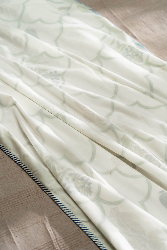 Light-colored fabric with subtle pattern on a wooden surface