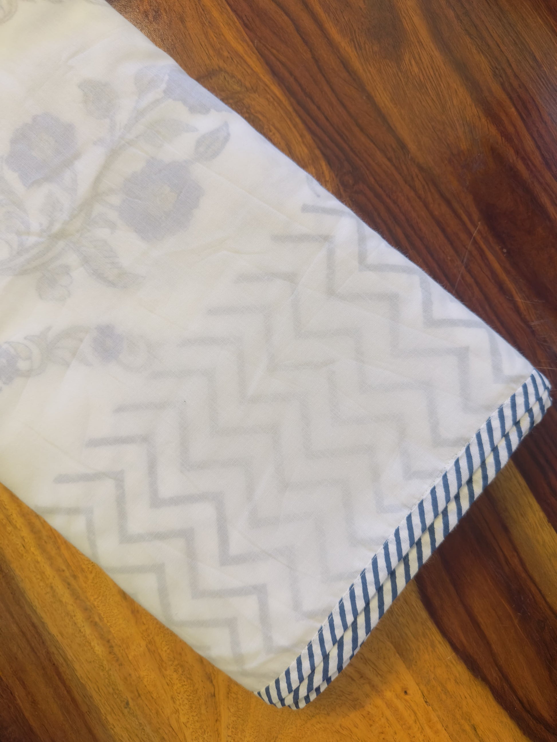 Rectangular fabric sample with zigzag pattern on a wooden surface