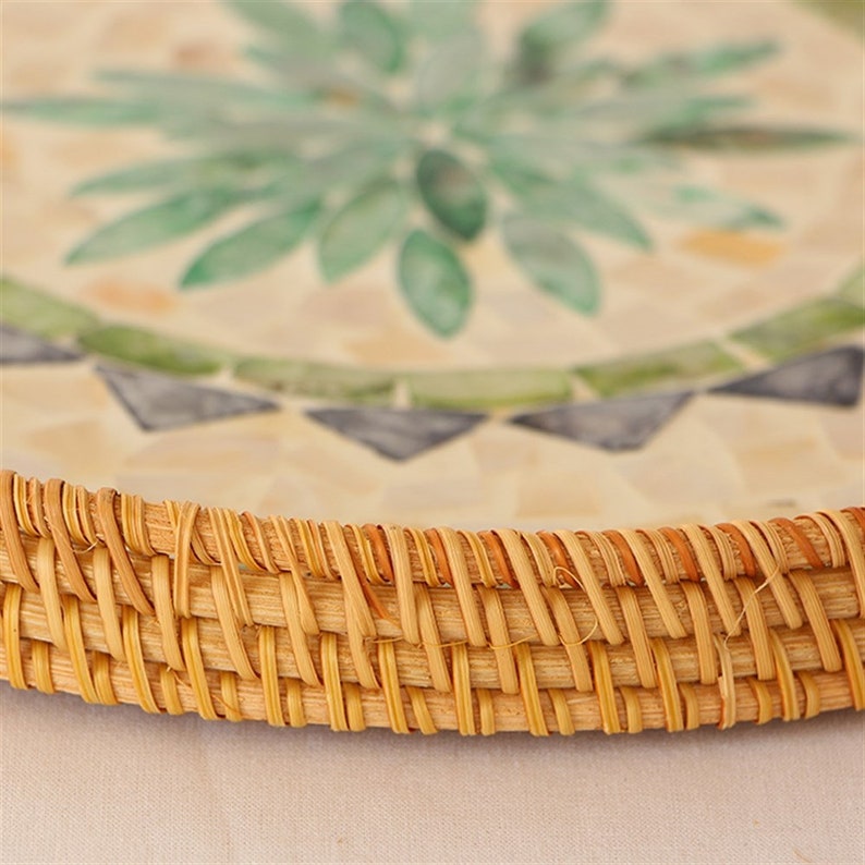 Handmade Pearl Inlay Rattan serving tray. Enhance your Dream Home with our curated selection of premium wall and Home Décor items. Round Mother Of Pearl Rattan Tray is made with handwoven rattan material mixed mother of pearl is durable and eco-friendly, add a natural touch to any room. Impress your guests with these beautiful hand woven serving trays made with natural Rattan. TESU 