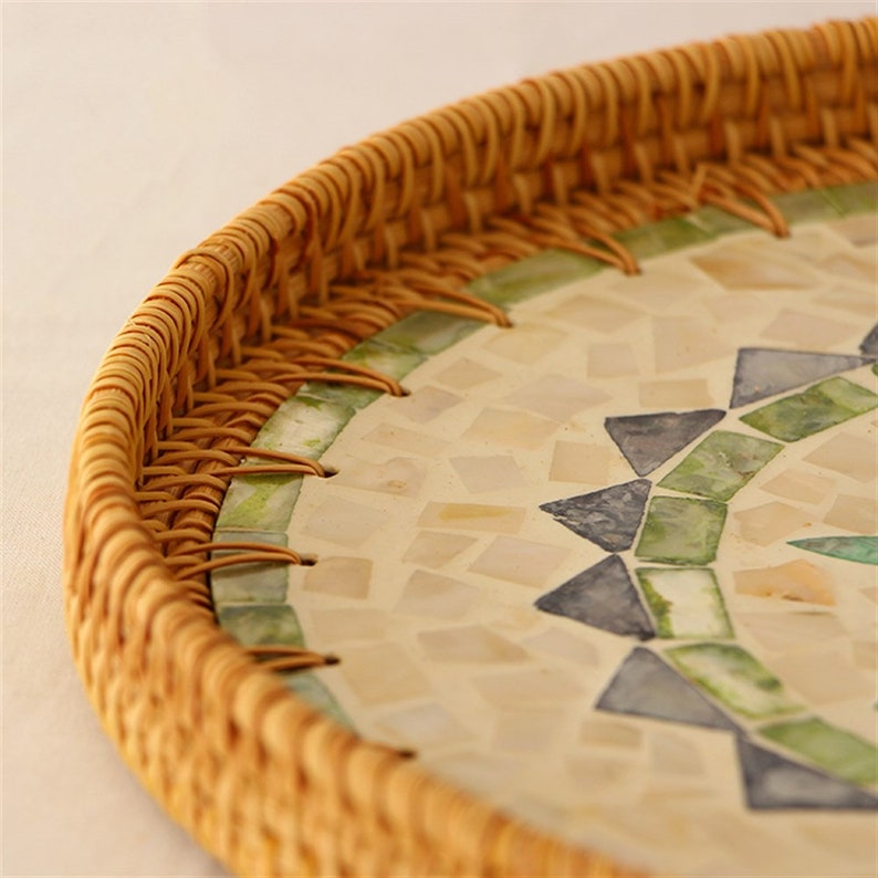 Handmade Pearl Inlay Rattan serving tray. Enhance your Dream Home with our curated selection of premium wall and Home Décor items. Round Mother Of Pearl Rattan Tray is made with handwoven rattan material mixed mother of pearl is durable and eco-friendly, add a natural touch to any room. Impress your guests with these beautiful hand woven serving trays made with natural Rattan. TESU 