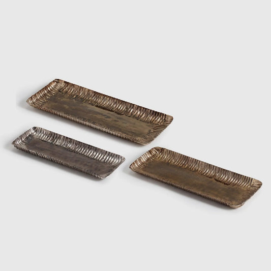 Elevate your space with the timeless charm of the Ravya Hammered Tray Set, a curated trio of handcrafted trays made from durable aluminium. 