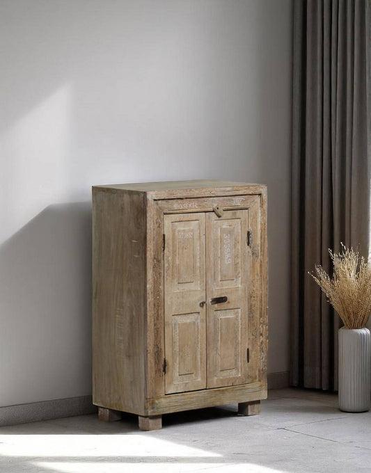Handcrafted from recycled wood and iron, this cabinet carries the character of the past while serving modern storage needs. 