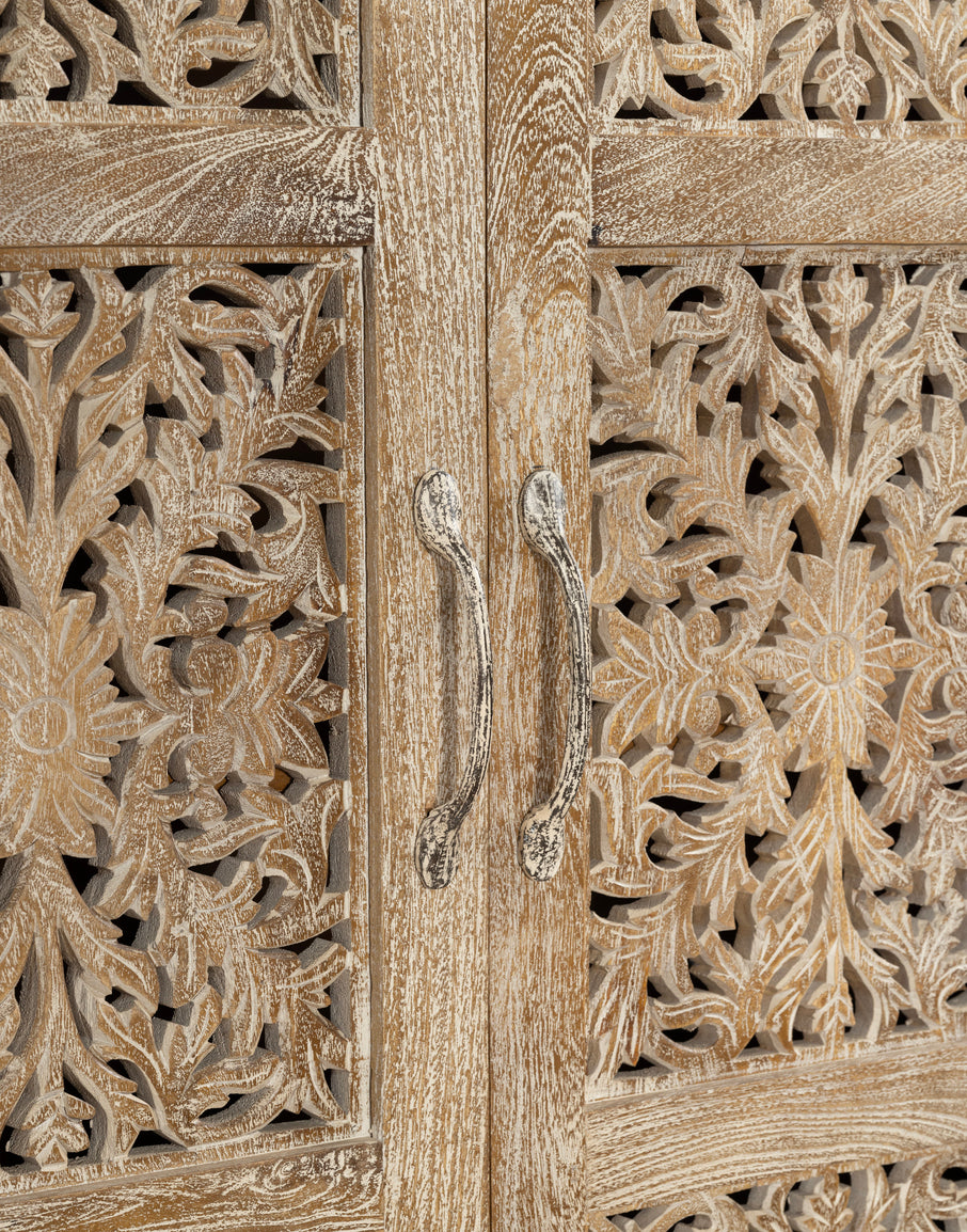 Wooden door with intricate carvings and a handle