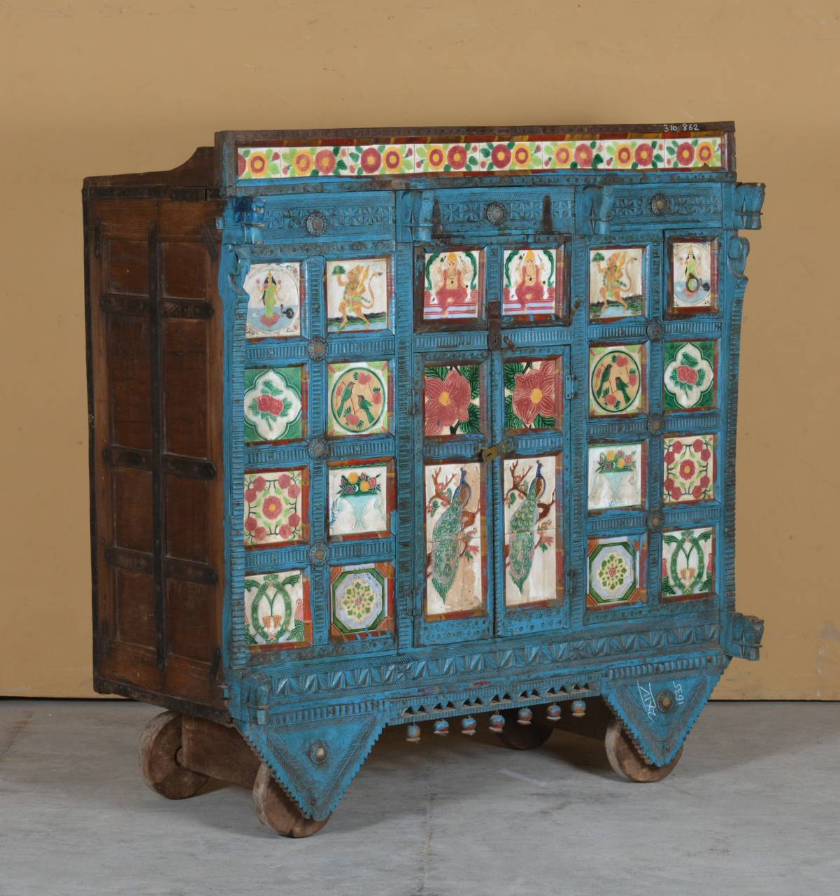  Handcrafted from durable teak wood, this traditional dowry chest is adorned with vibrant hand-painted panels featuring floral motifs, 