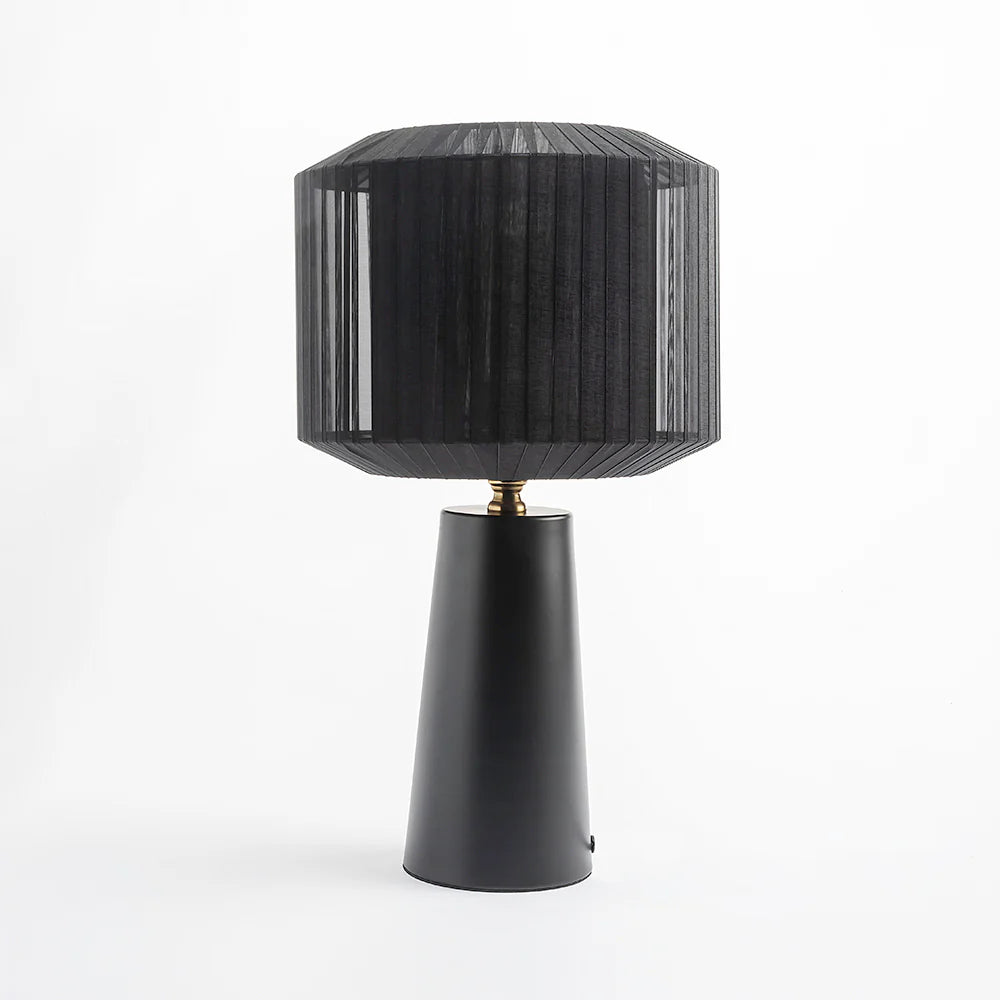 Featuring a sleek metal base and a sculptural ribbon-wrapped shade, 