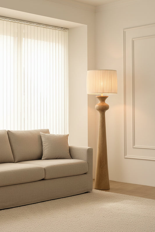 Solenne Floor Lamp with sculpted oak wood base and pleated fabric shade in a modern Scandinavian-style interior.