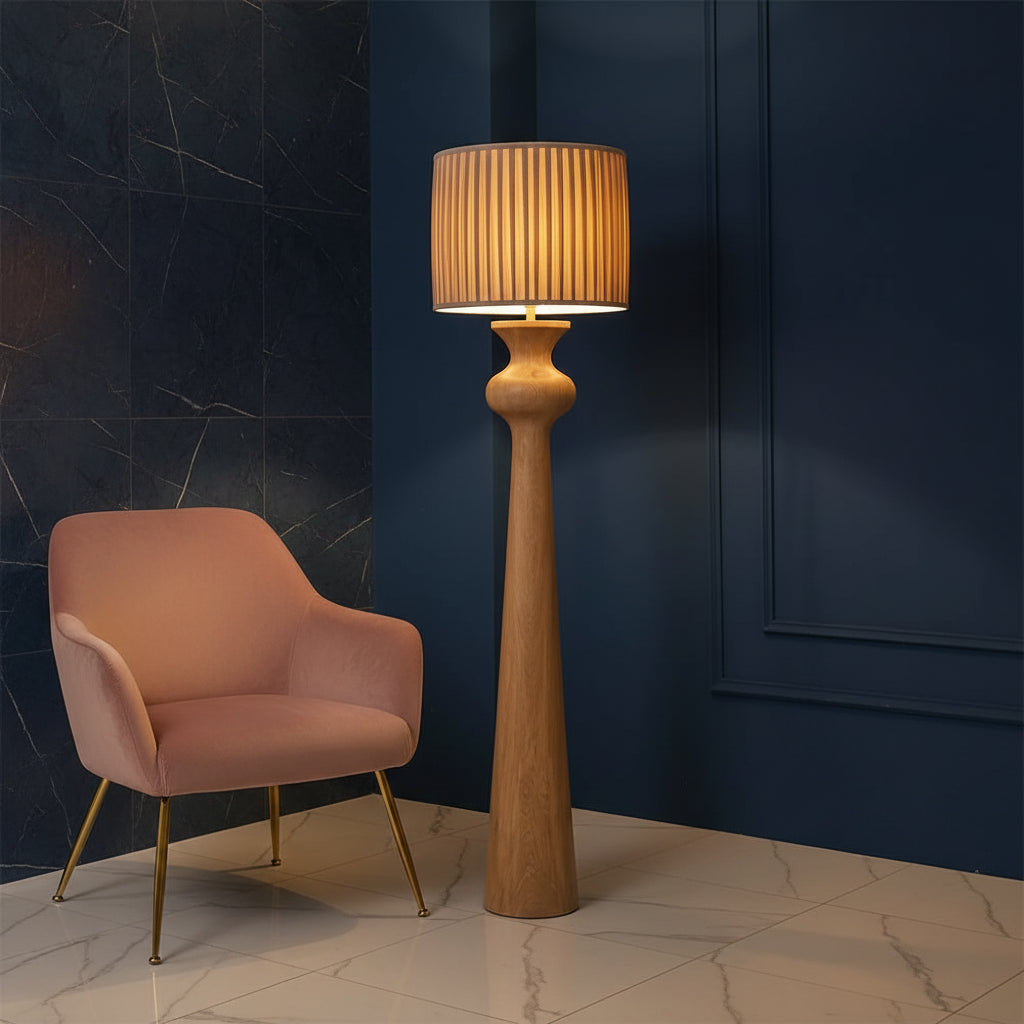 Solenne Floor Lamp with sculpted oak wood base and pleated fabric shade in a modern Scandinavian-style interior.