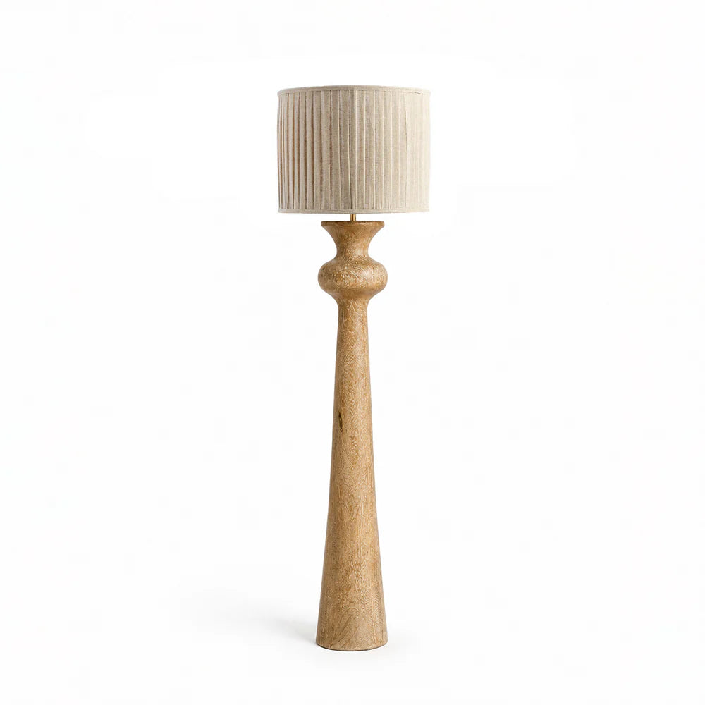 "Solenne Floor Lamp with sculpted oak wood base and pleated fabric shade in a modern Scandinavian-style interior."