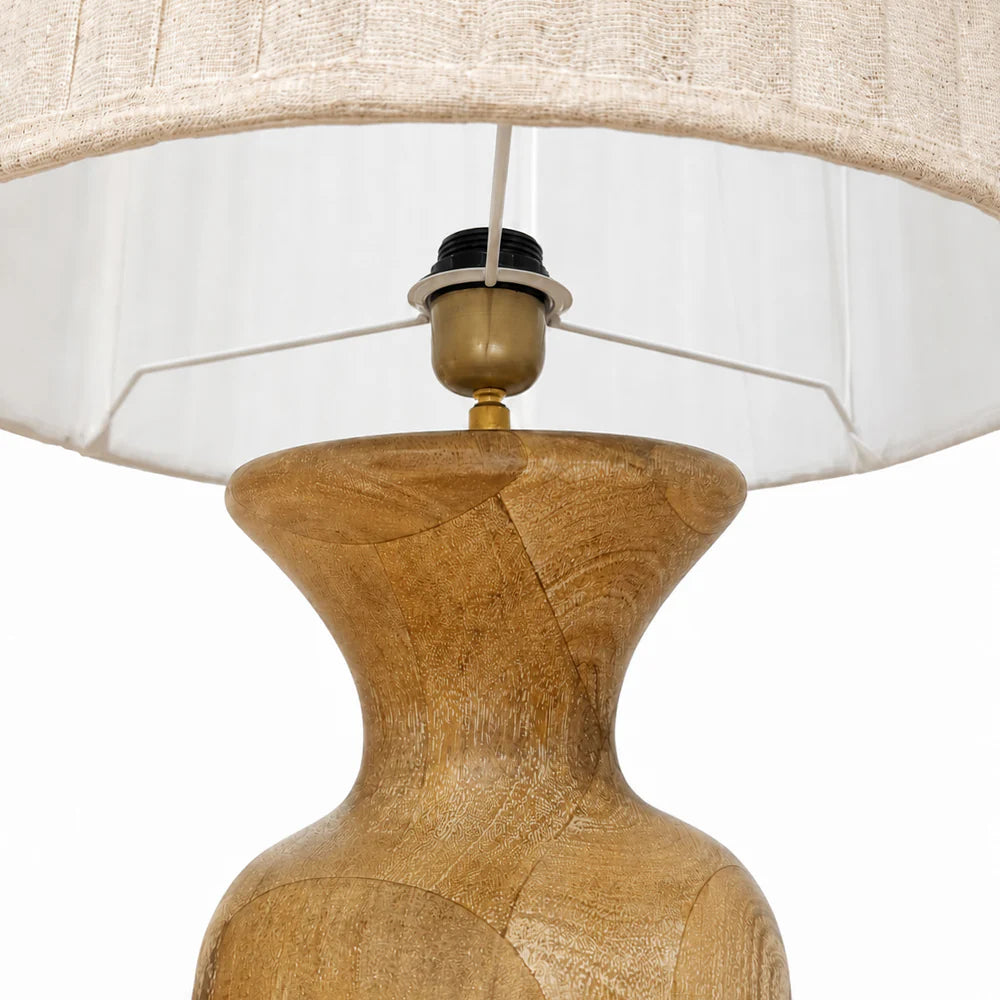 "Solenne Floor Lamp with sculpted oak wood base and pleated fabric shade in a modern Scandinavian-style interior."