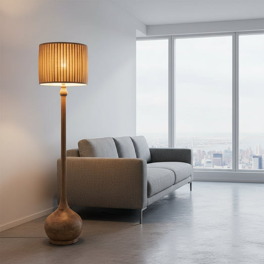 Floor lamp with a textured shade next to a chair in a room with a window and curtains.
