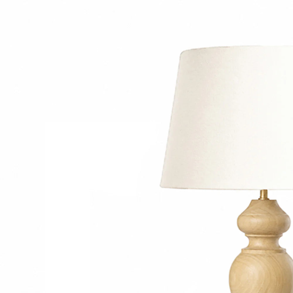 Table lamp with a beige base and white shade on a white background