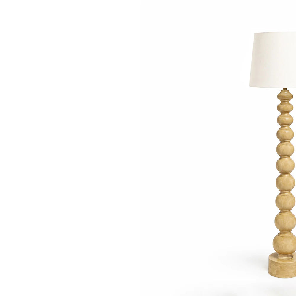 Wooden floor lamp with a white shade on a white background