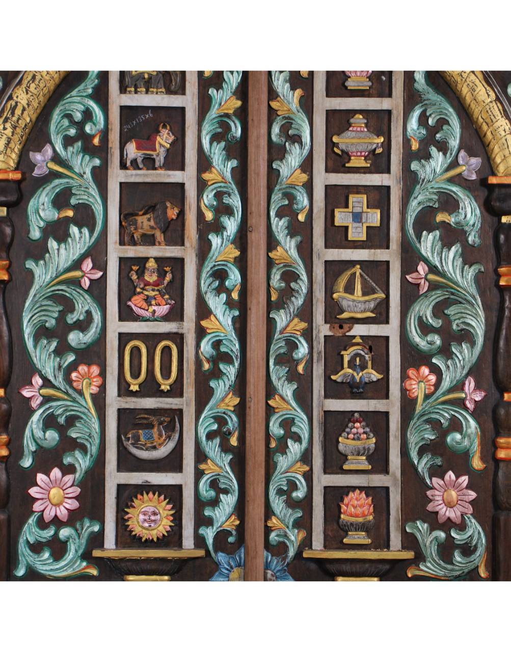 Each carved section tells a story — from celestial beings to sacred emblems like the Shankh (conch), Kalash (sacred pot), Trishul (trident), and Chakra,