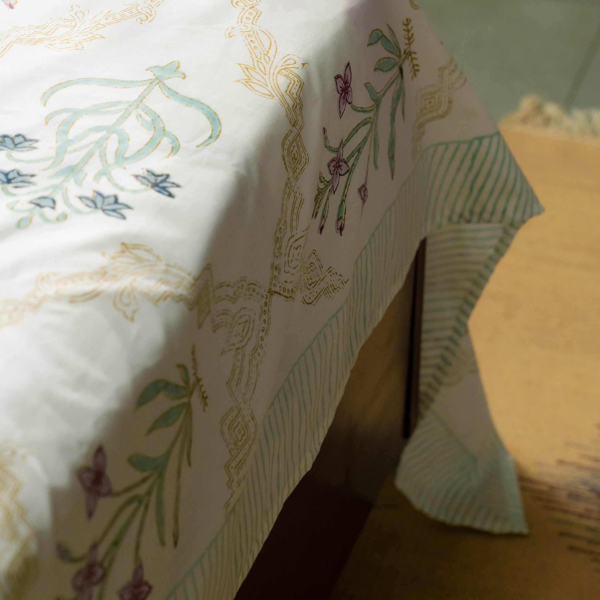 Floral patterned tablecloth on a wooden table