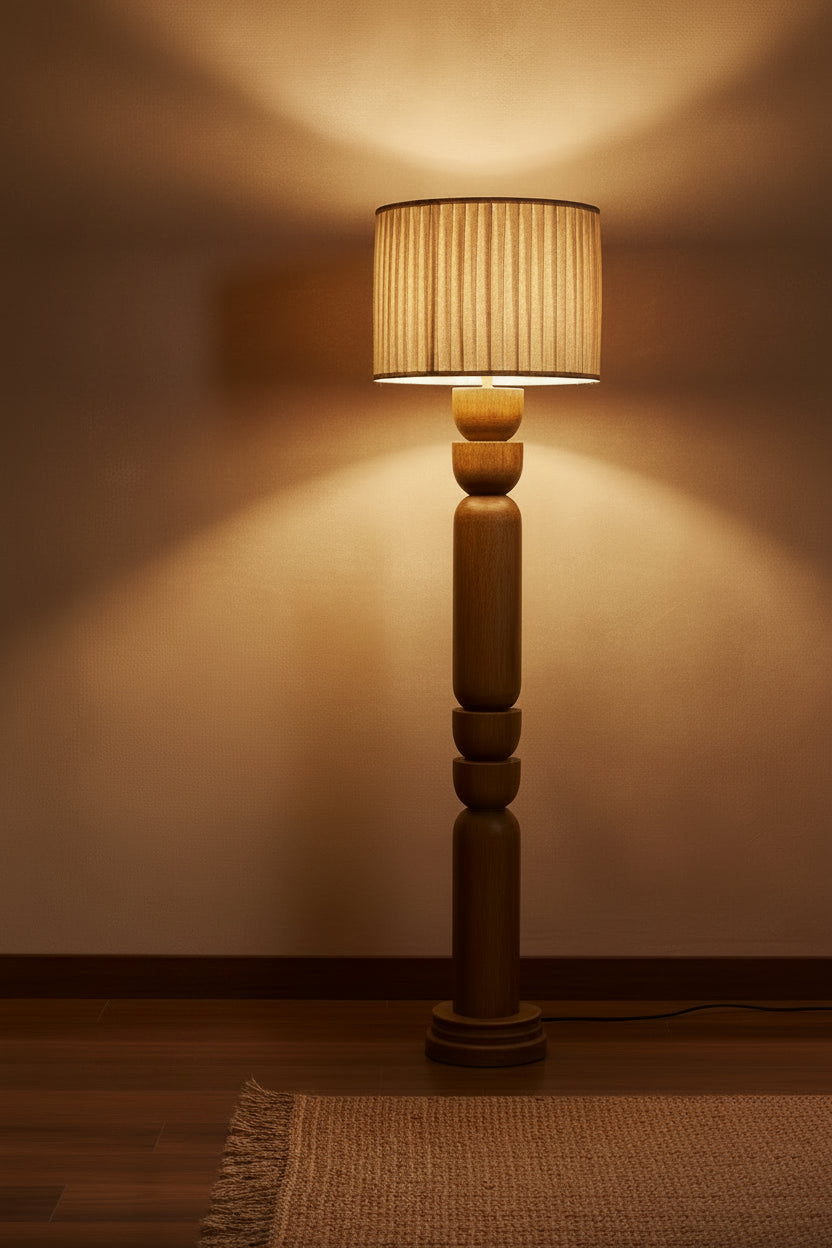 Floor lamp with wooden base and beige pleated shade on a white background