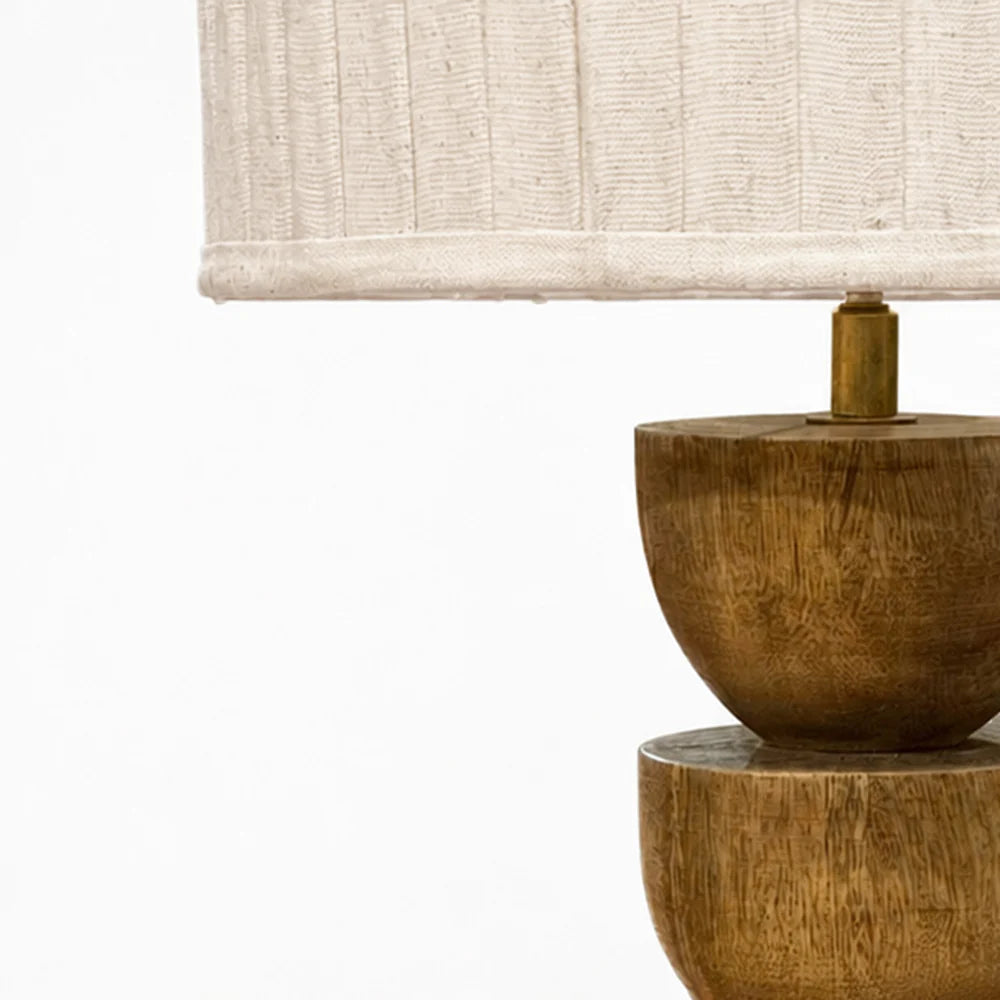Wooden table lamp with a beige lampshade on a white background