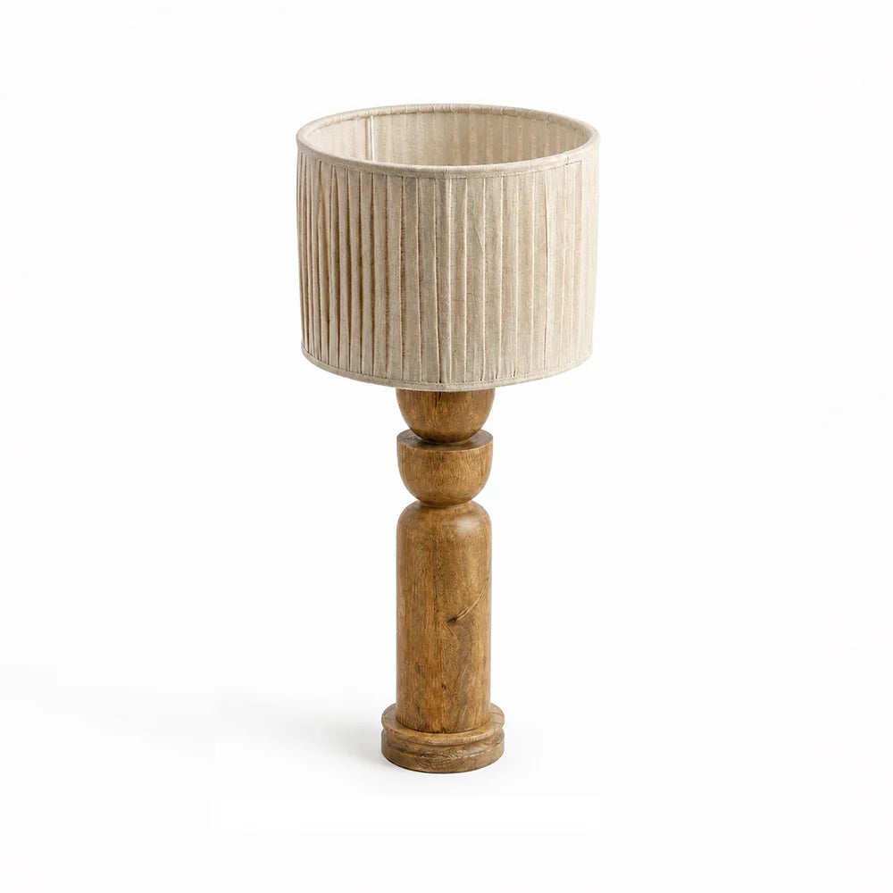 Table lamp with wooden base and beige pleated shade on a white background