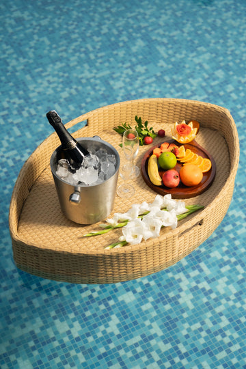 Floating breakfast tray Poolside luxury Pool party essentials Versatile pool floats Rattan style design Handcrafted in Bali Synthetic fibers Environmentally friendly Non-toxic materials Multiple uses Hot tub accessory Summer pool party Portable serving tray Resort amenities Unique guest experiences Luxury pool accessories Innovative hotel amenity tesu 